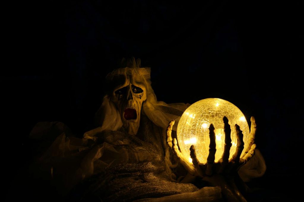 skeleton looking at crystal ball