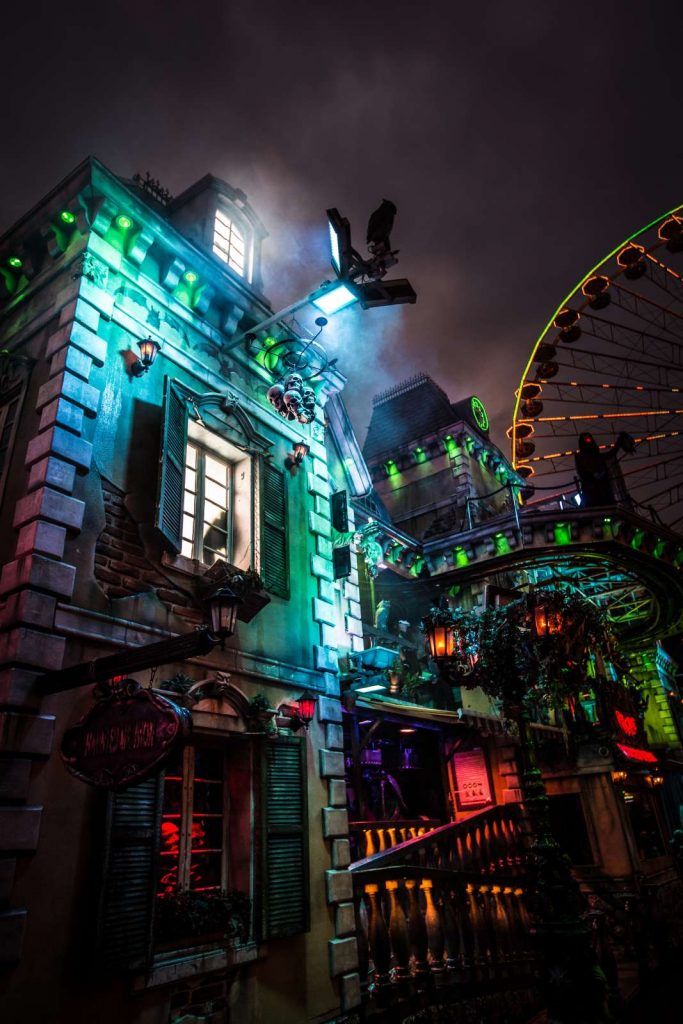 haunted house at carnival with ferris wheel in the background