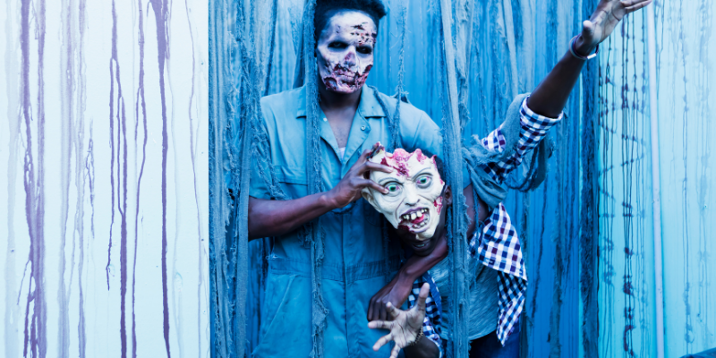 scary zombie standing in front of wooden fence