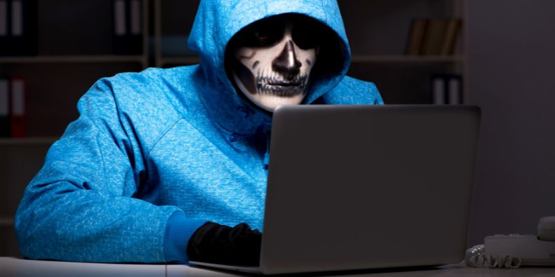 man with painted face working on a computer