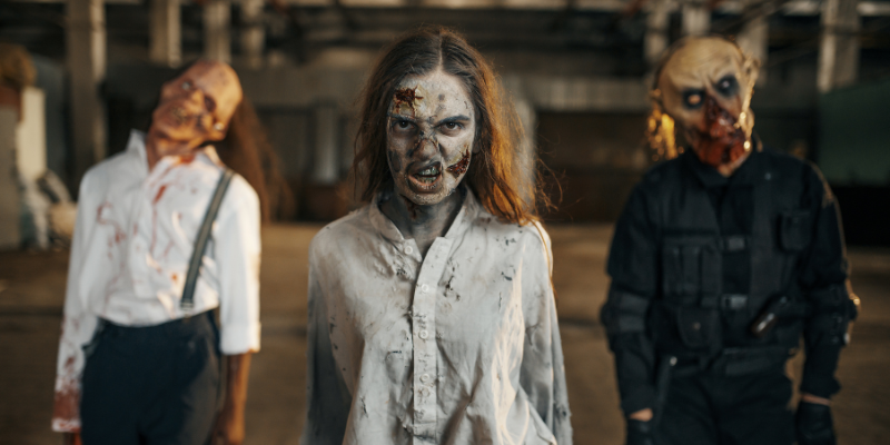 Three zombie figures walking towards the camera.