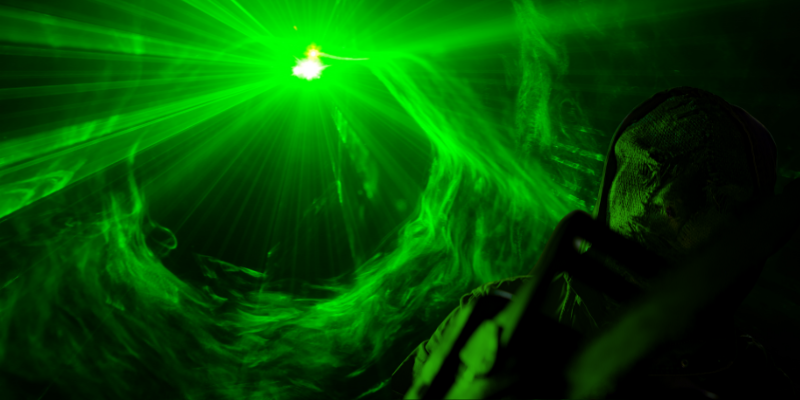 scare actor holding chainsaw with smoke swirling