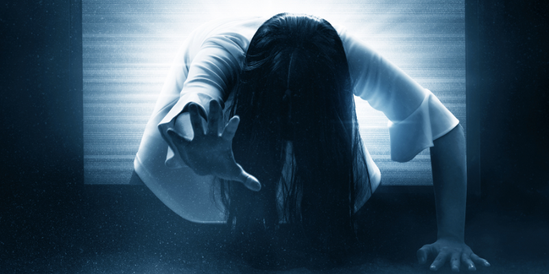 woman dressed in white reaching for audience through computer screen