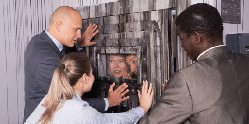 people stuck in a room being helped by others