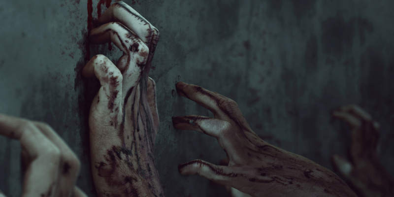 Bloody zombie hands on a cement wall