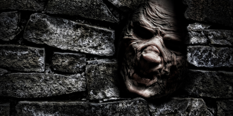 Horror monster looking out from hole in the wall