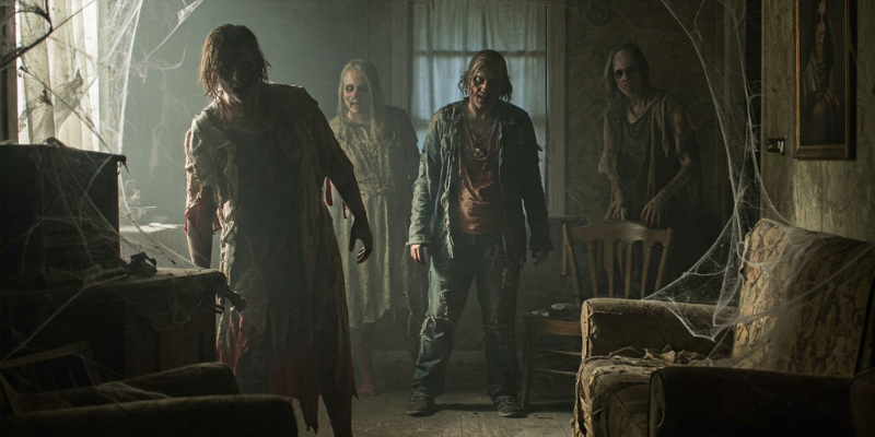 Zombies lurking inside a spooky room with cobwebs and old furniture
