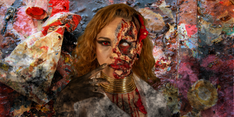 Woman in frightening Halloween zombie makeup surrounded by fog and messy paint