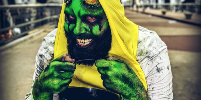 Murve Slimesworth in banana costume grinning and holding bucket for Halloween candy