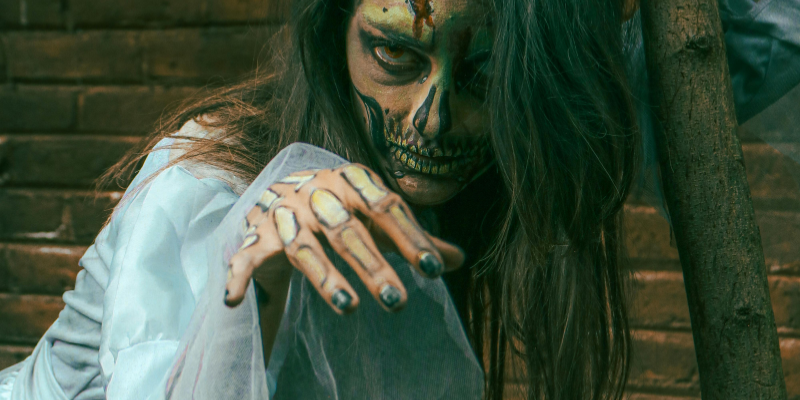 Spooky Halloween zombie girl lurking toward the camera