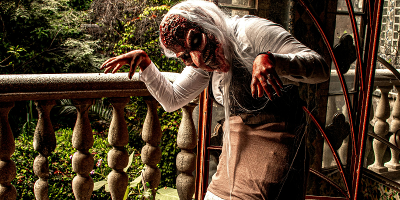 Creepy zombie costume in haunted setting